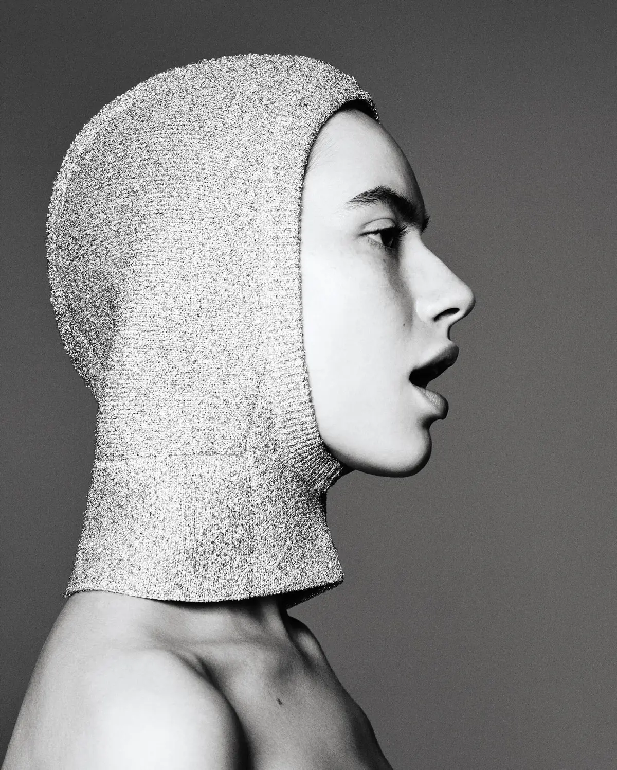 Aoife Simone in profile wearing a silver knit hood